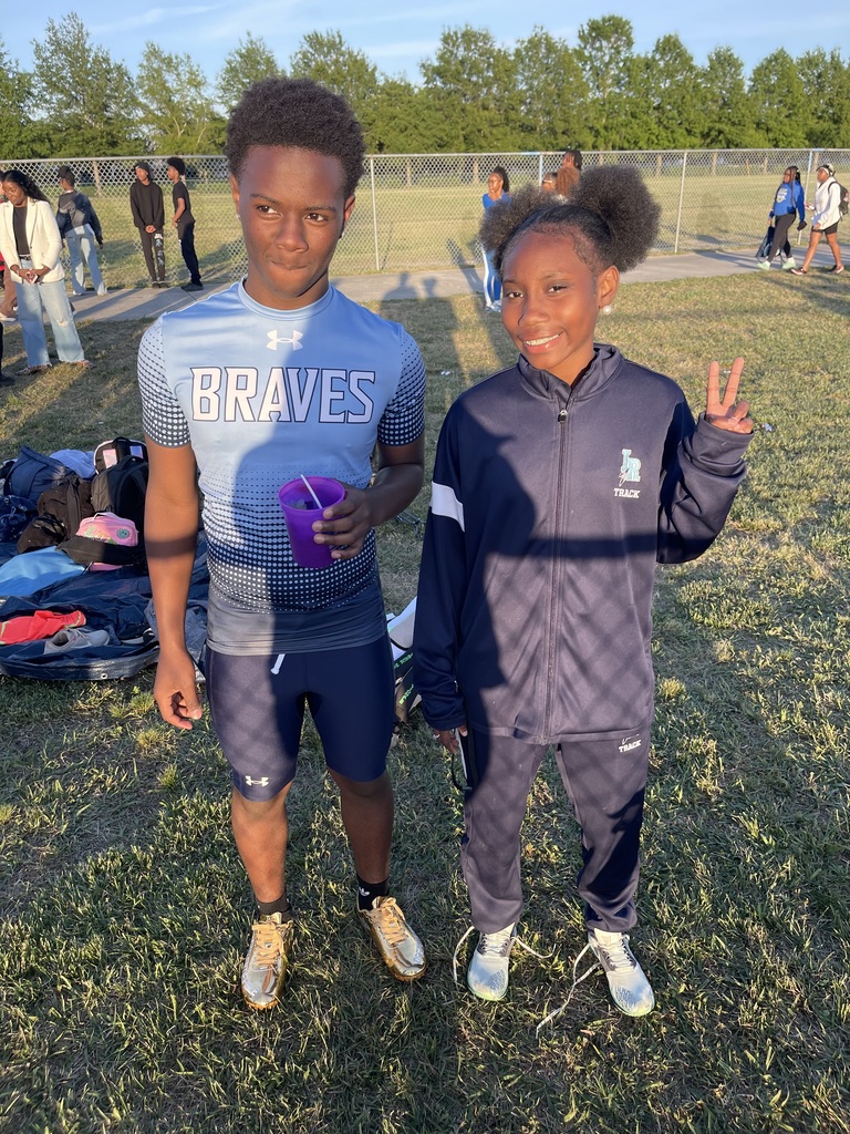 Middle School Track Athletes standing in the grass at the Citywide track meet