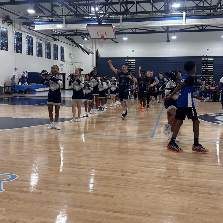 Faculty coming out getting excited for the game to start with cheerleaders.