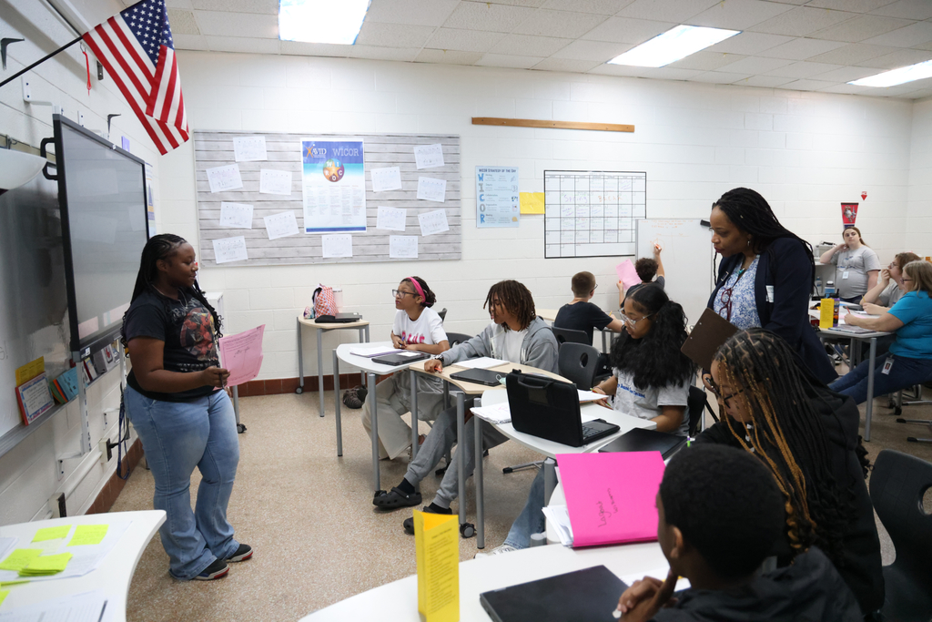 A lesson taking place with a student leading it and other students contributing.