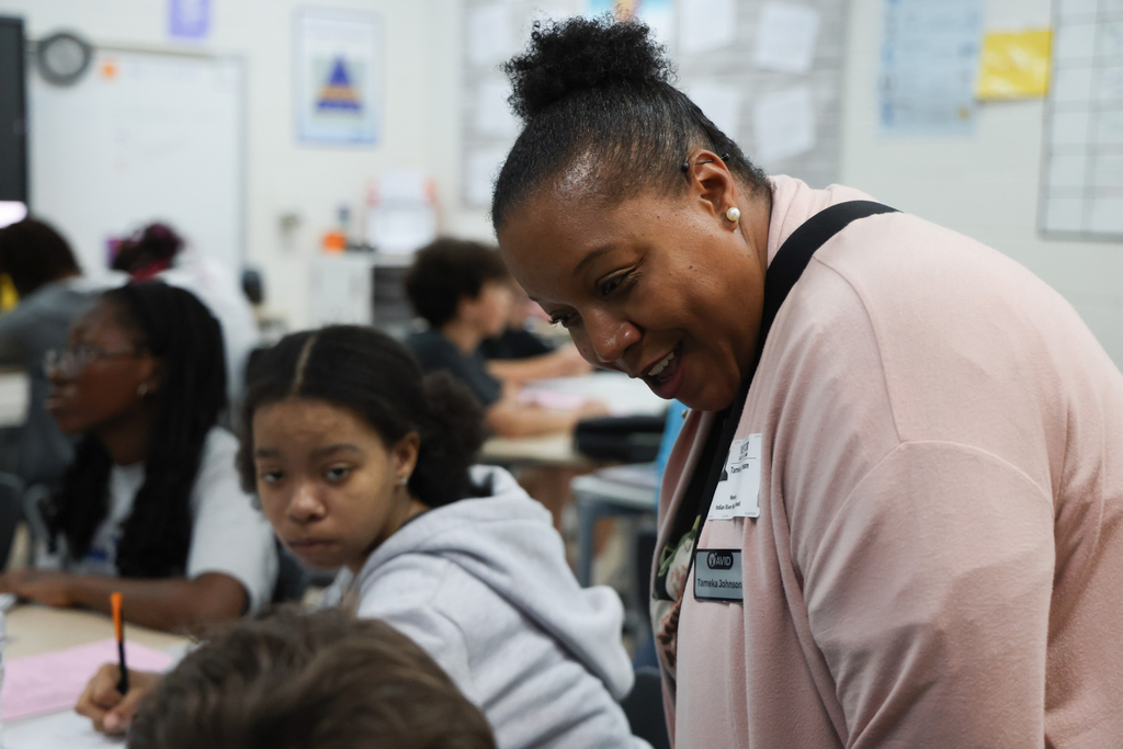 An AVID representative working with a student.