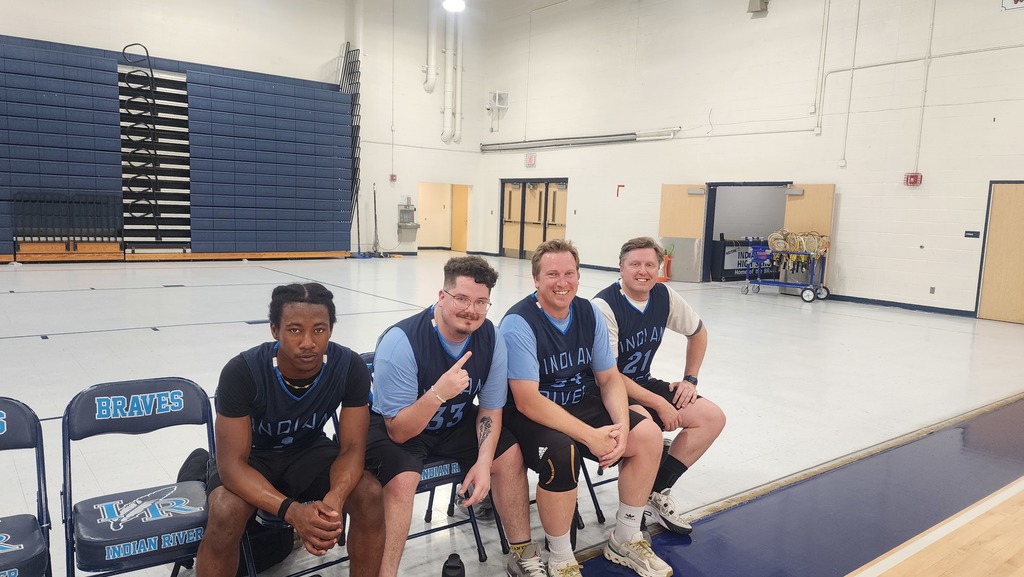 Some of the SRI Faculty Basketball Team sitting in chairs.