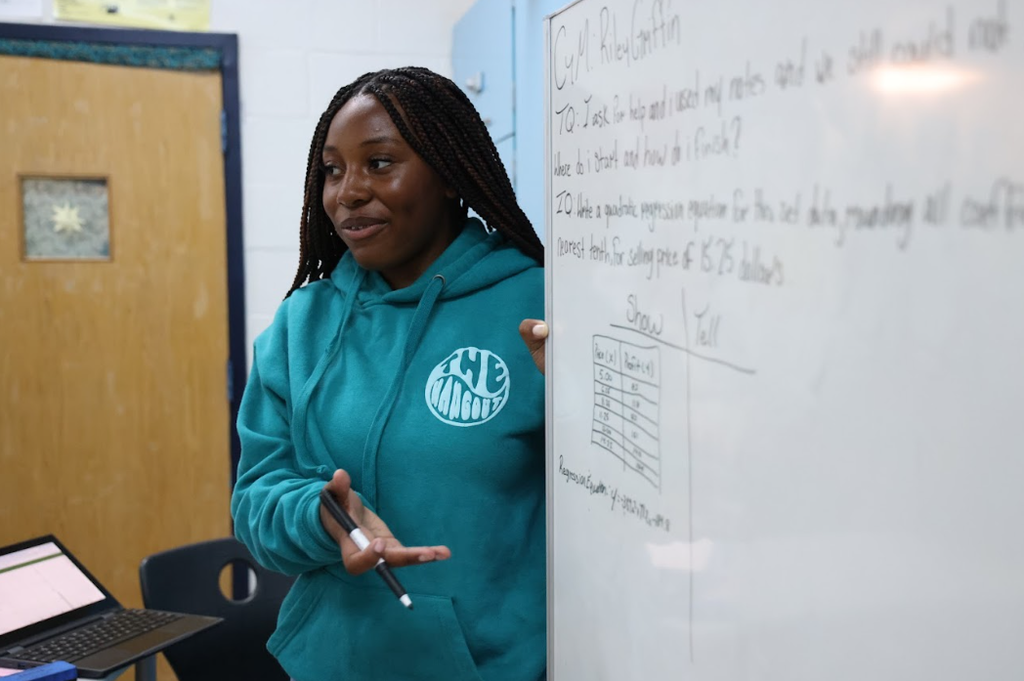 middle school student leading a discussion using a whiteboard