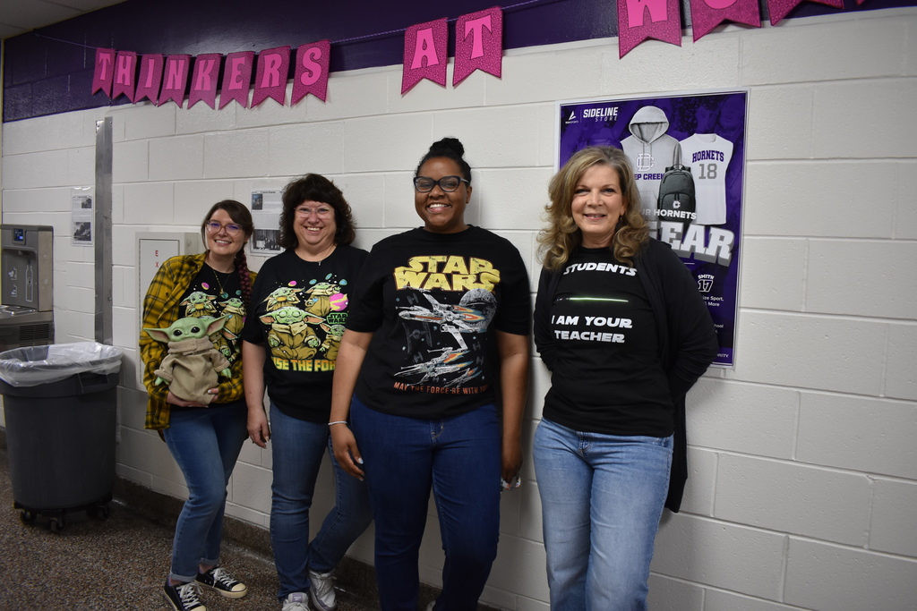 Four teachers  wearing a their star wars tshirts!