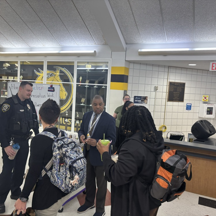 teachers receiving a teacher appreciation candy from administrators