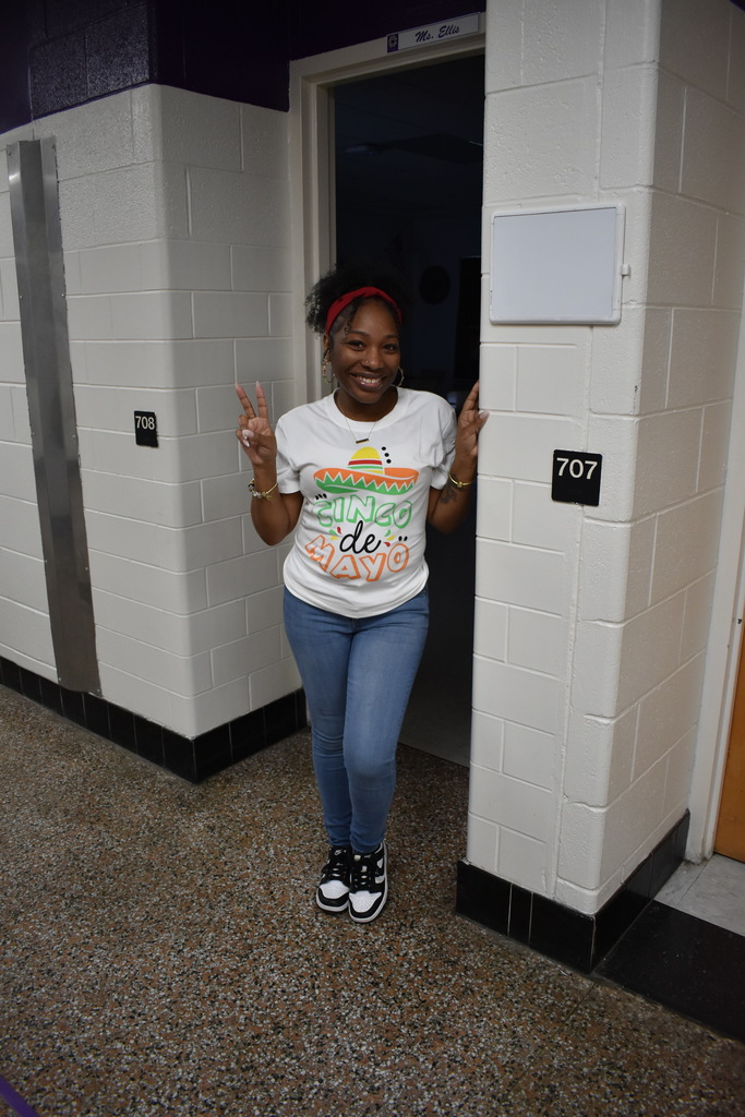 A teacher dressed in the colors on the Mexican flag celebrating Cinco De Mayo