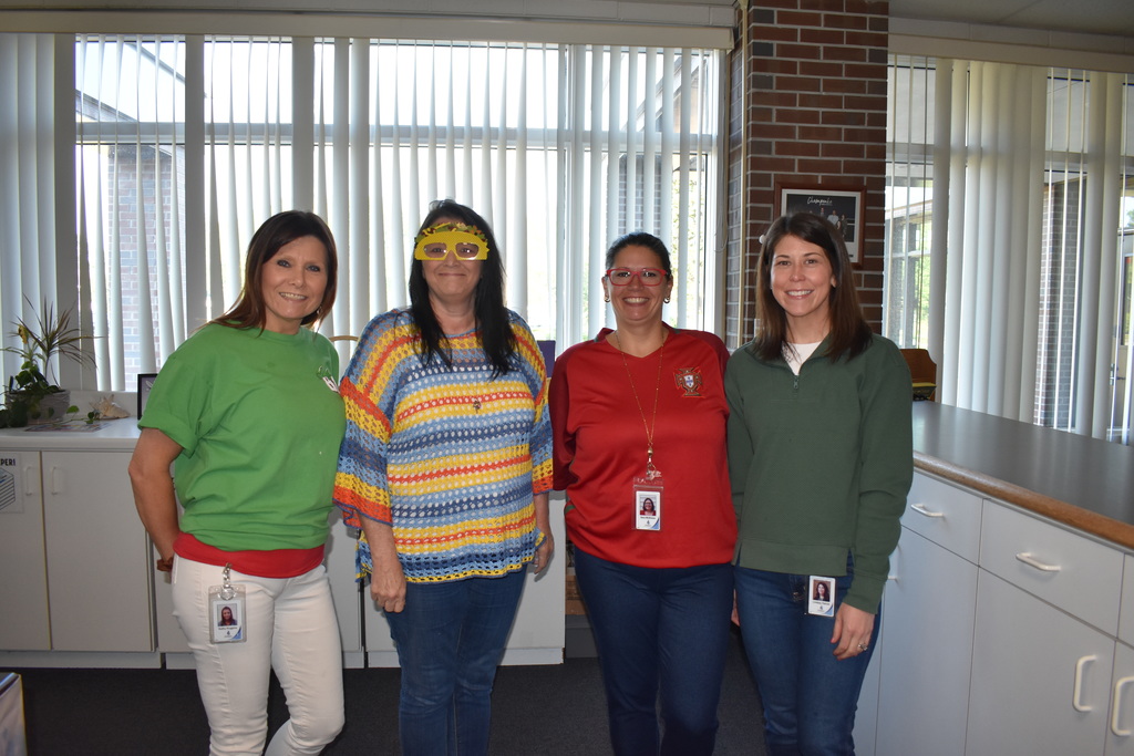 Four Staff members dressed in the colors on the Mexican flag celebrating Cinco De Mayo
