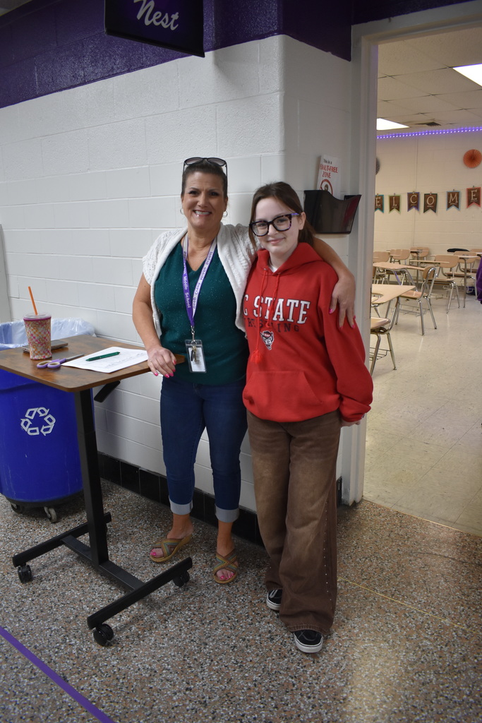 A teacher and student dressed in the colors on the Mexican flag celebrating Cinco De Mayo