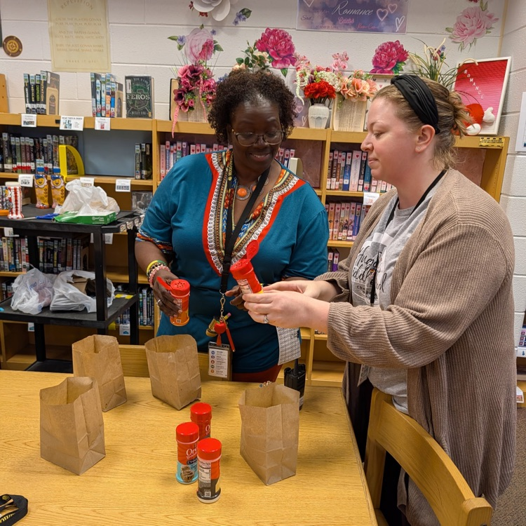 Teachers making popcorn and smiling