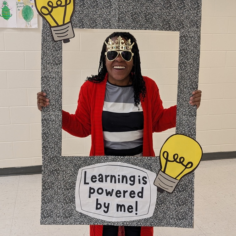 teacher, smiling with selfie station