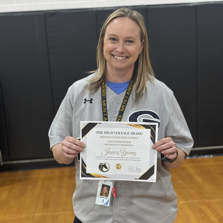teacher, smiling, holding award