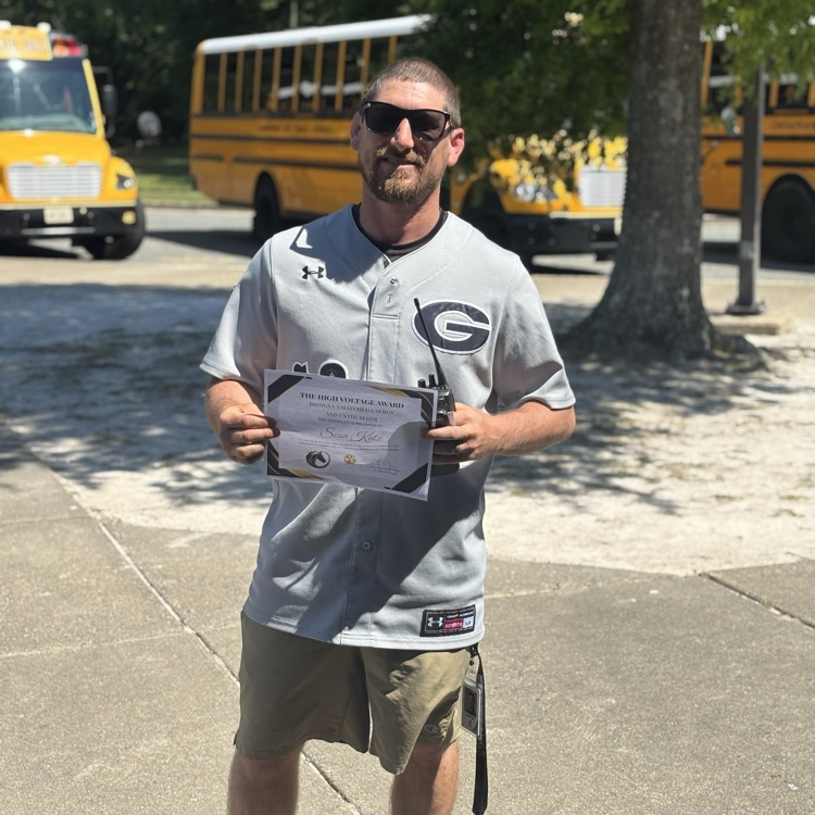 teacher, smiling, holding award