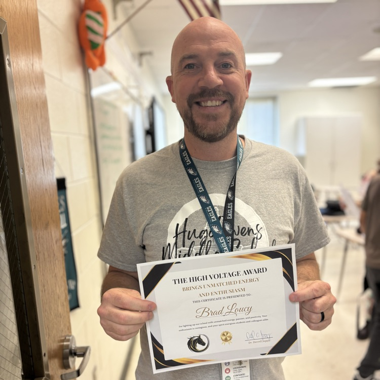 teacher, smiling, holding award