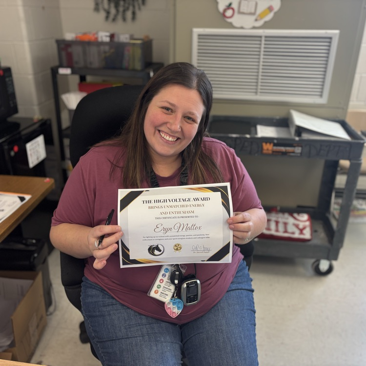 teacher, smiling, holding award