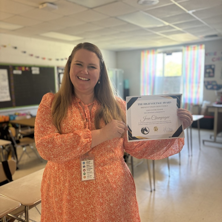 teacher, smiling, holding award