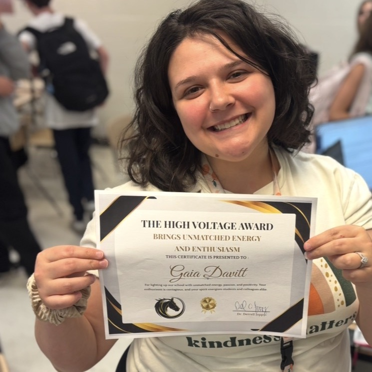 teacher, smiling, holding award