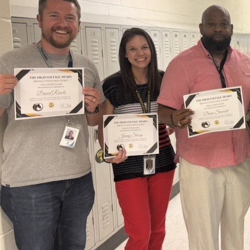 teachers, smiling, holding award