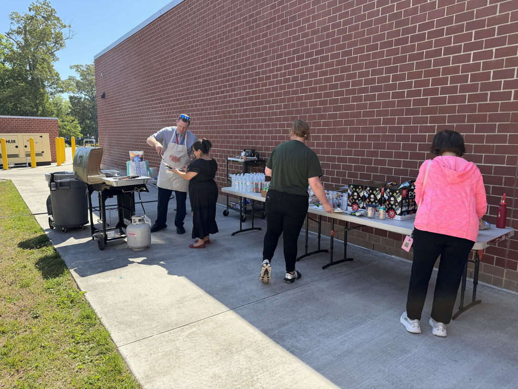 Staff members excitedly getting their cookout lunch provided by Mr. Mason on Staff Appreciation Week