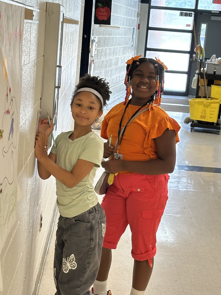 Students doing activity on wall