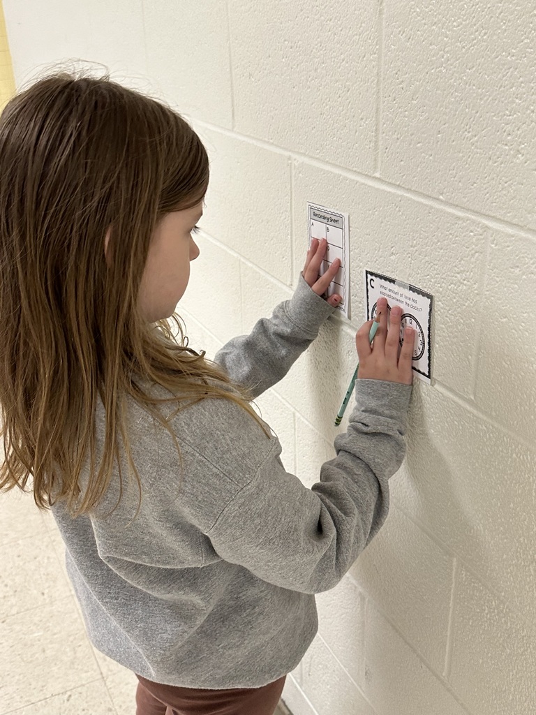 Students doing activity on wall