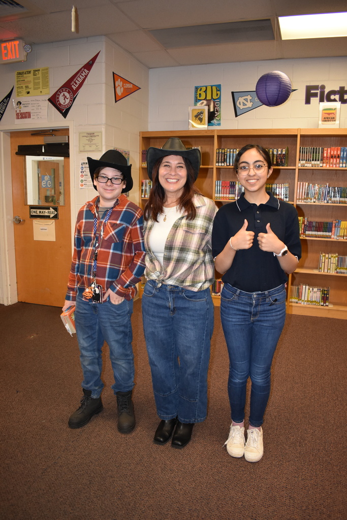 A student and a teacher in their cowboy outfits vs a preppy student