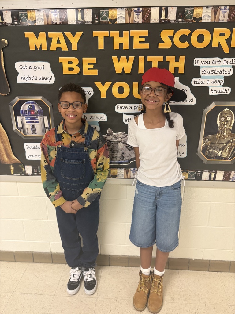 Class standing against wall with 90s wear