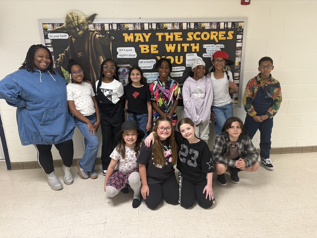 Class standing against wall with 90s wear