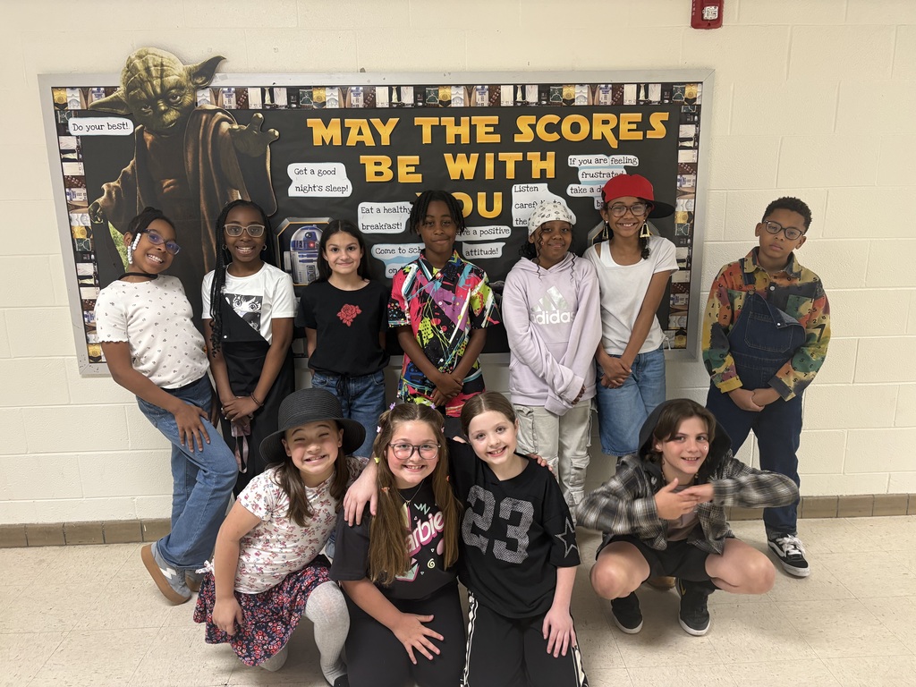 Class standing against wall with 90s wear