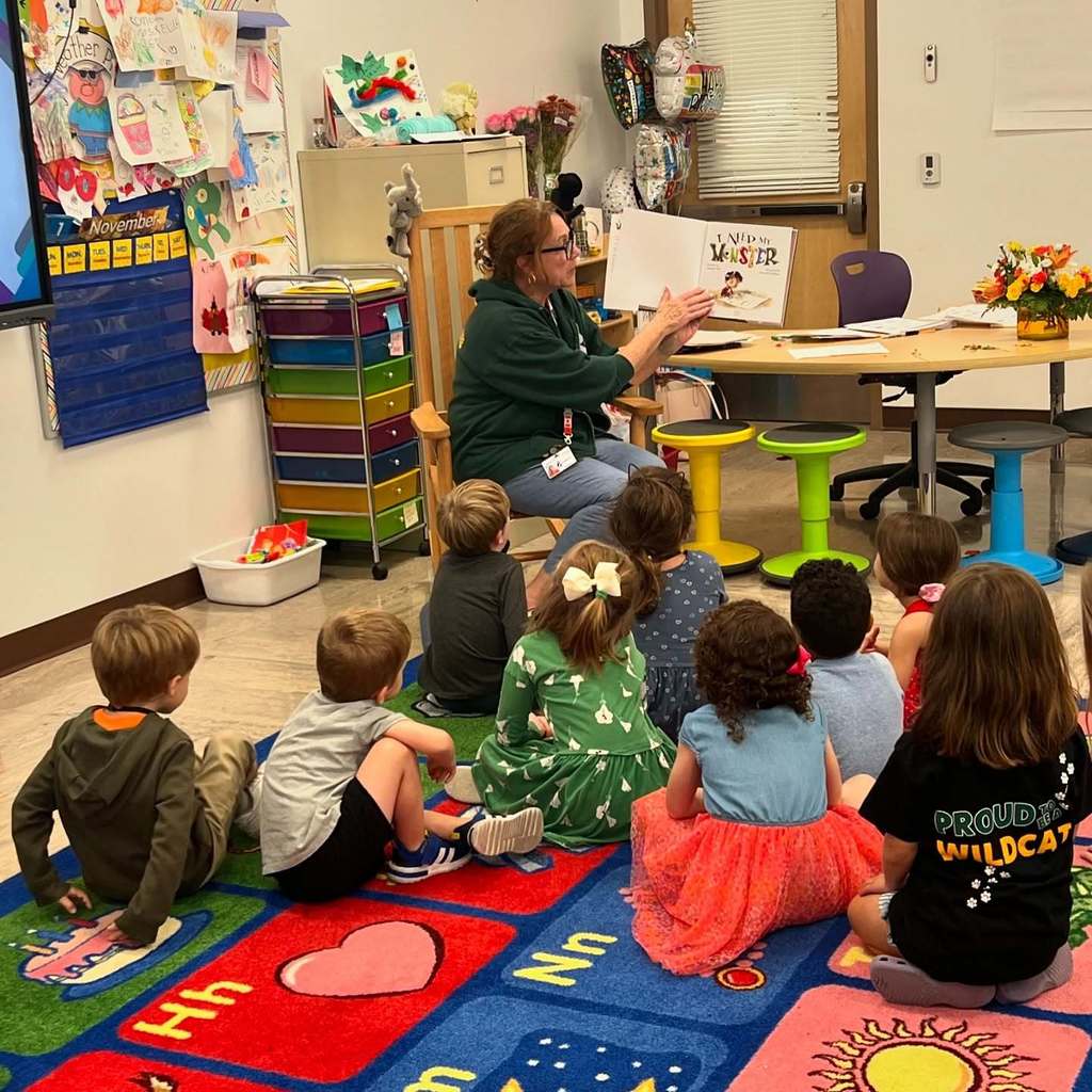 Mrs. Kelleher reading a book to her students