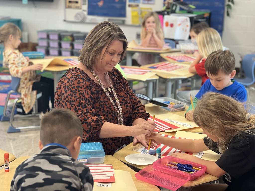 Mrs. Brinn working with her students on a craft in her classroom