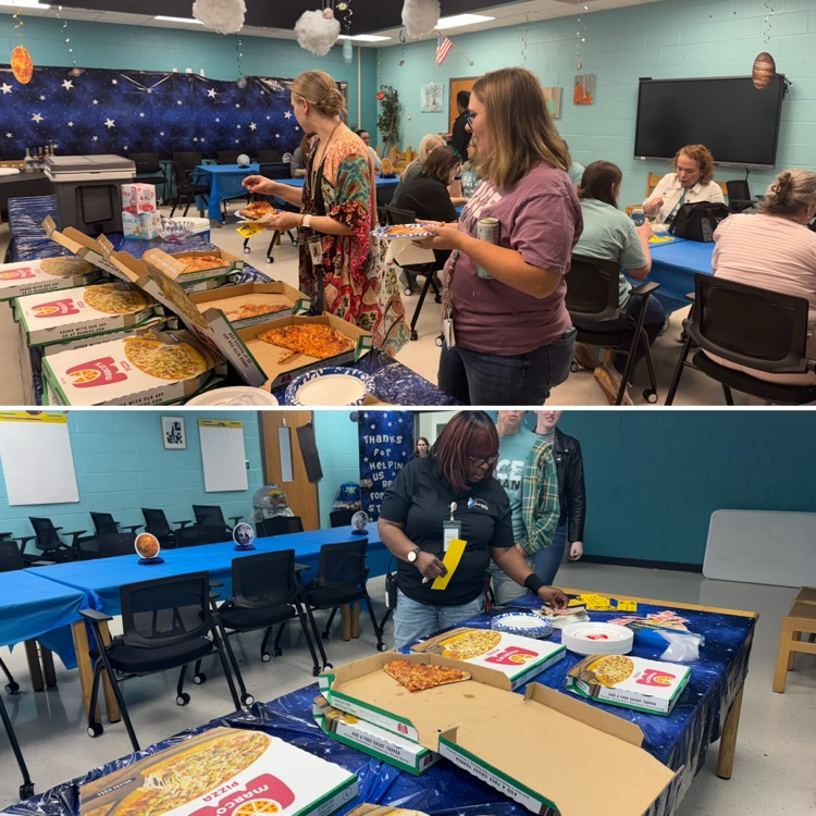 Teachers lining up to grab pizza 