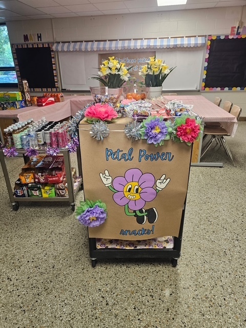 Two carts with drinks and snacks and a sign that says Petal Power Snacks.