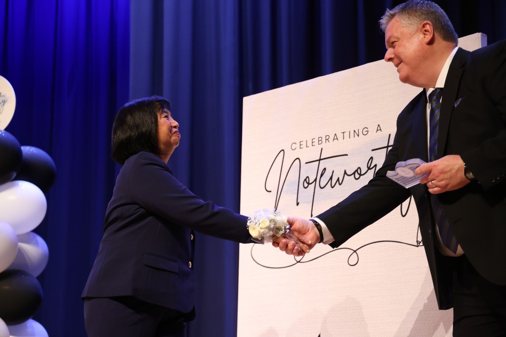 Retiree shaking hands with the Superintendent. 
