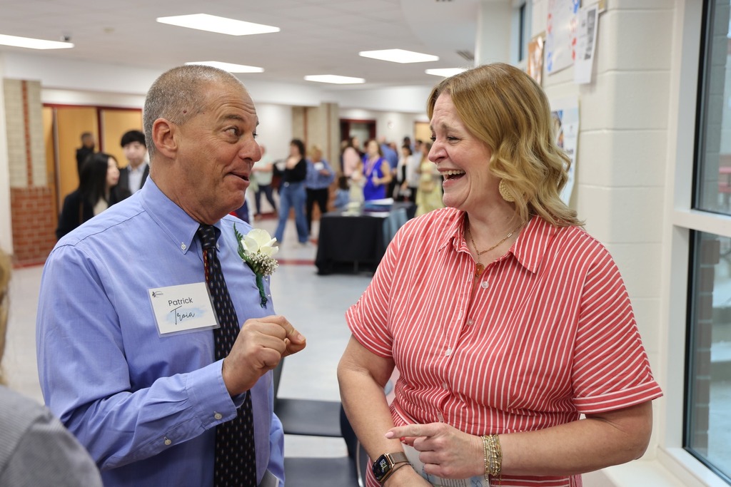 Retiree smiling speaking and laughing with his principal.