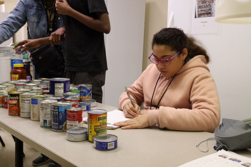Students and teachers happily collect and sort community donations