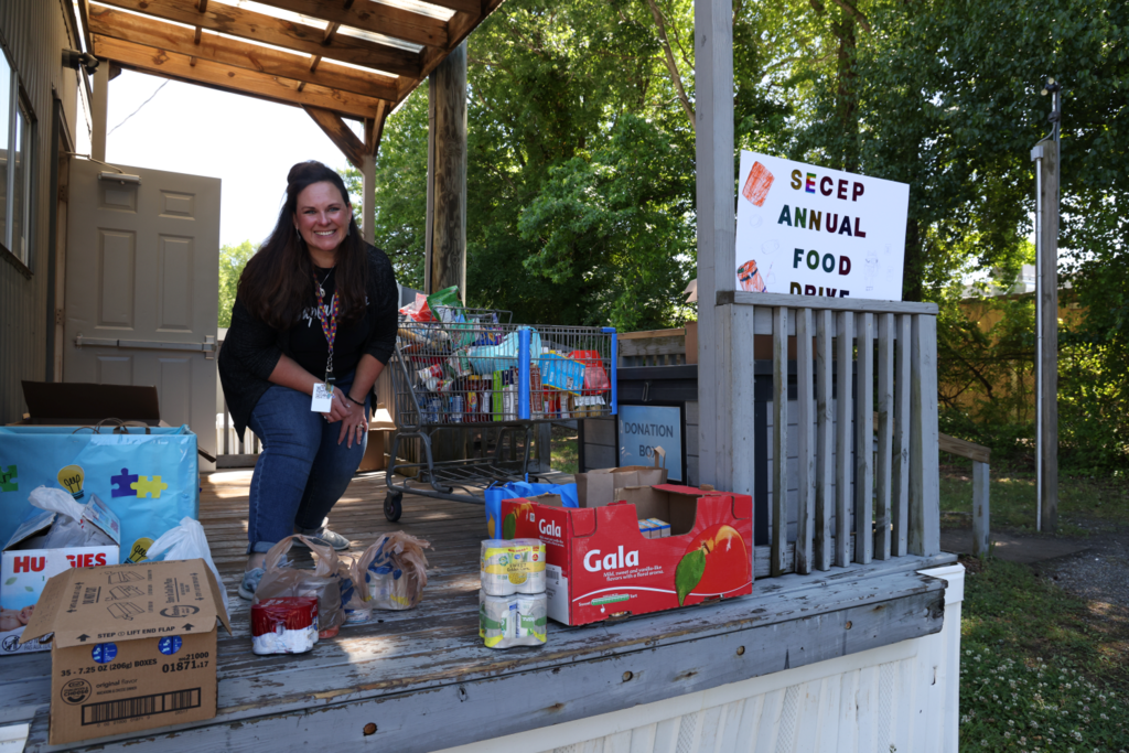 Students and teachers happily collect and sort community donations