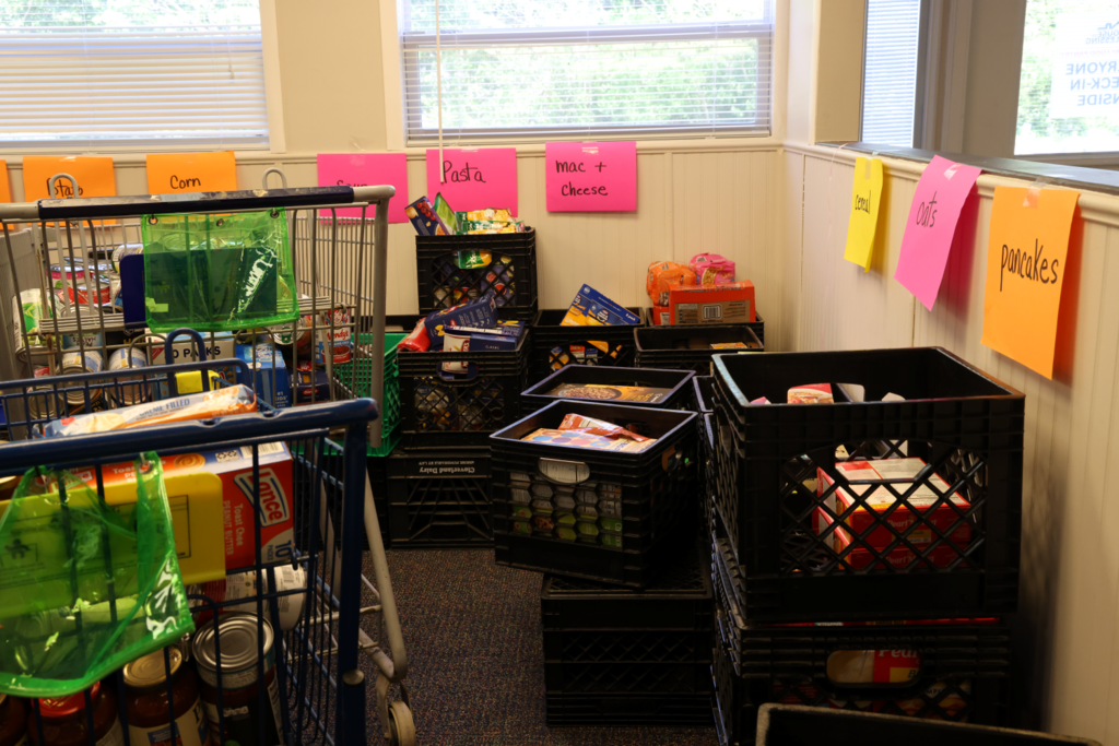 Students and teachers happily collect and sort community donations