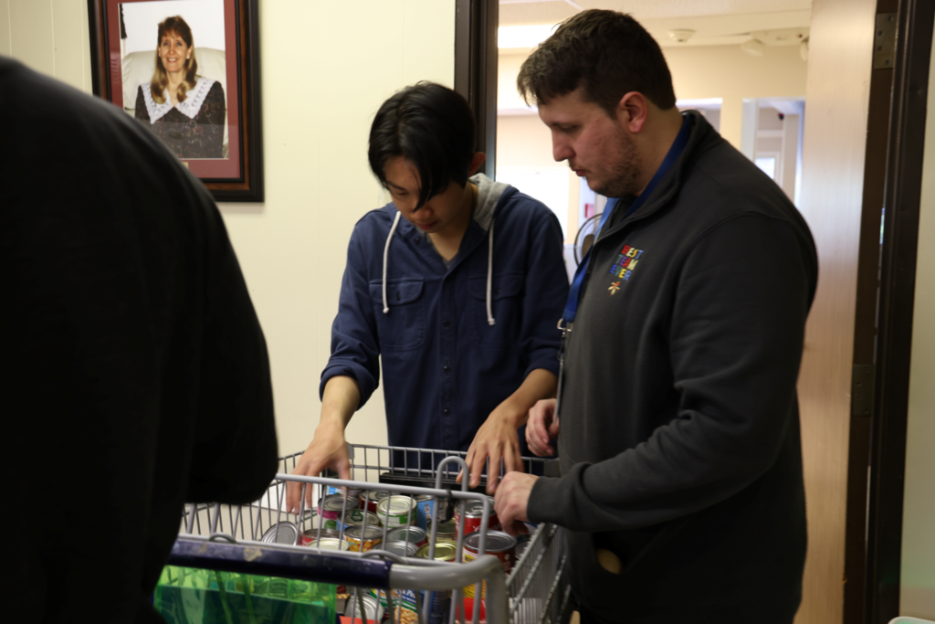 Students and teachers happily collect and sort community donations