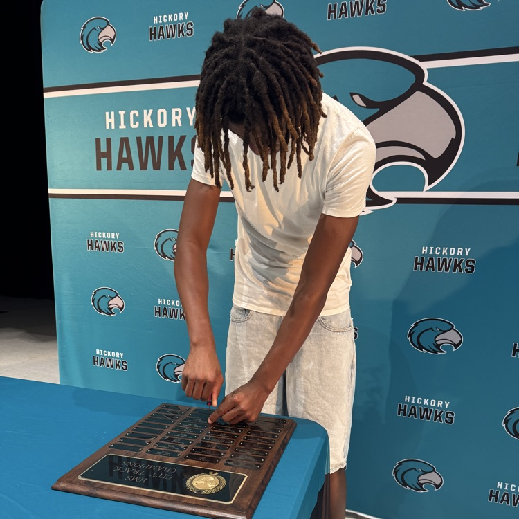 students placing their nameplate  on the plaque