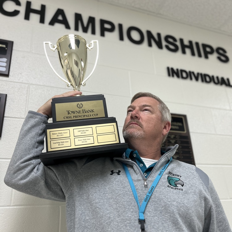 principal proudly looking off in to the distance while displaying our trophy