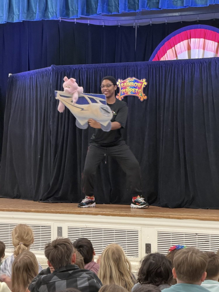 actor displaying a Mother Goose story with a flying prop