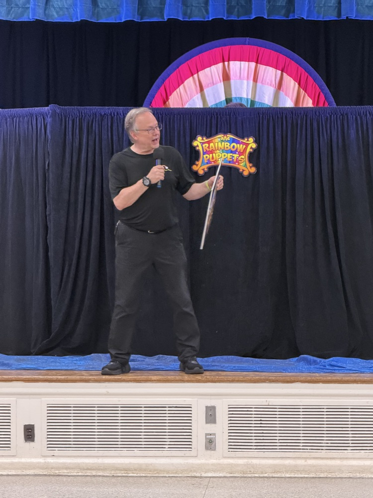 Actor sharing a mother story with a puppet