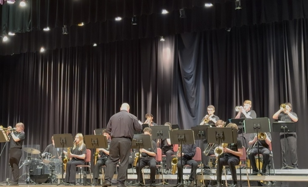 band director on stage with the jazz band members
