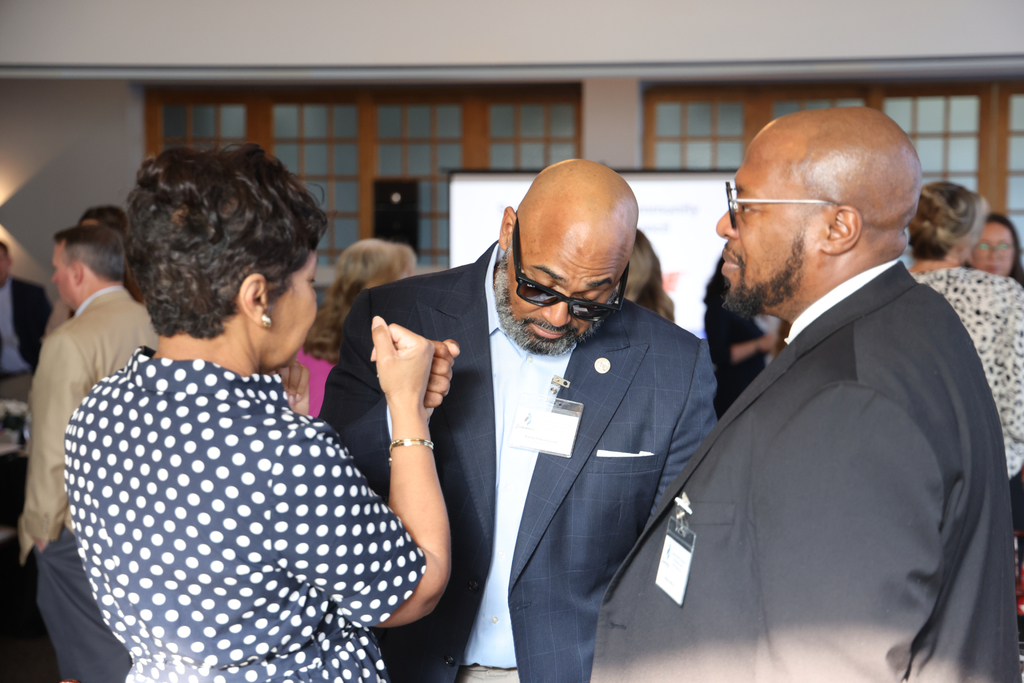 Community leaders fist bumping together.