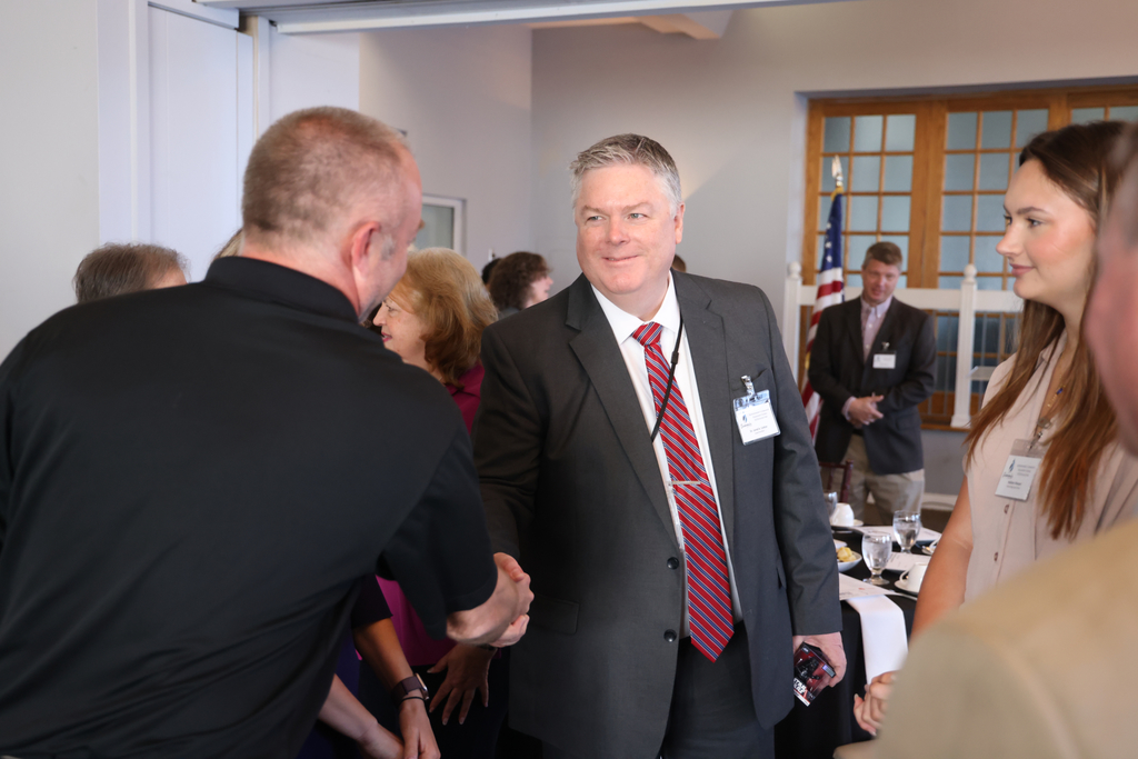 Dr. Cotton shaking hands with community leaders.