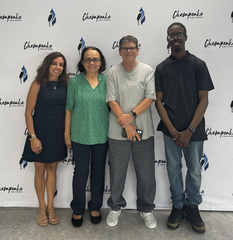 Four members of the Butts Road Intermediate custodial team pose together in front of a Chesapeake Public Schools backdrop after receiving the 2025–2026 Superior Custodial Team award for Exemplary Customer Service.