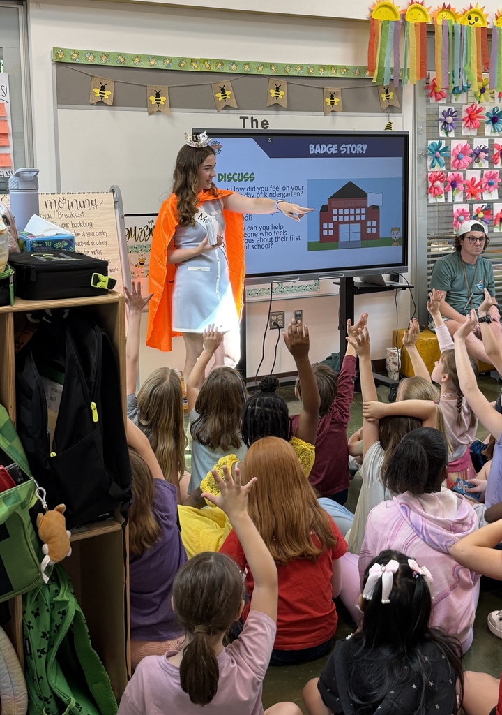 Students eagerly raise their hands during Miss Indian River's lesson as she points to call on a student to answer a question.