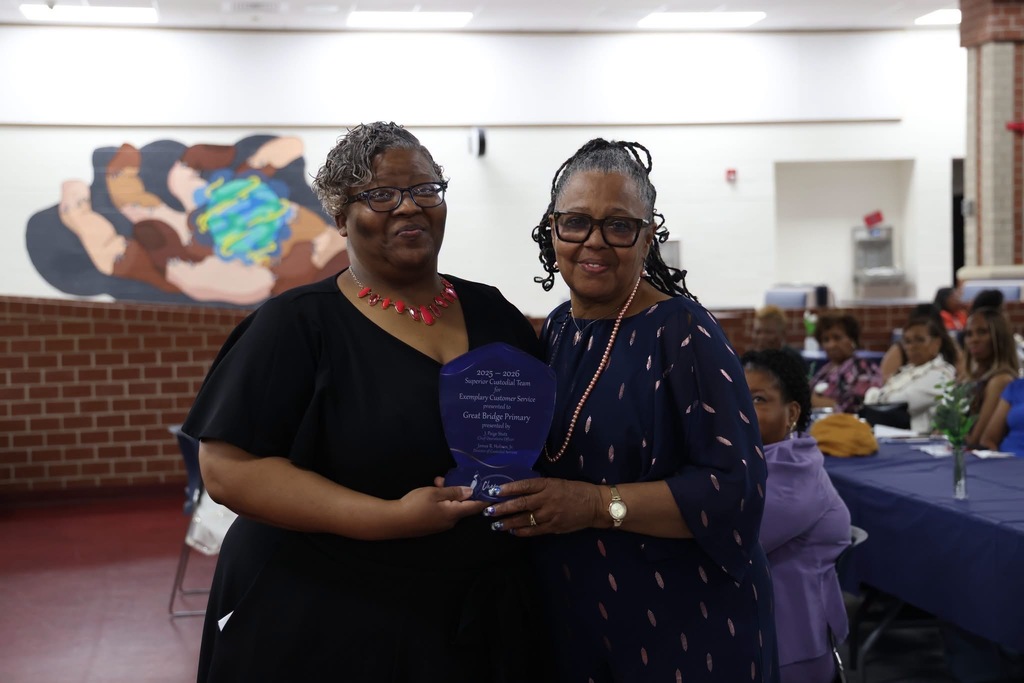 Our head custodian, Mrs. Harper, posing proudly as she accepts the superior award that was presented to GBP.