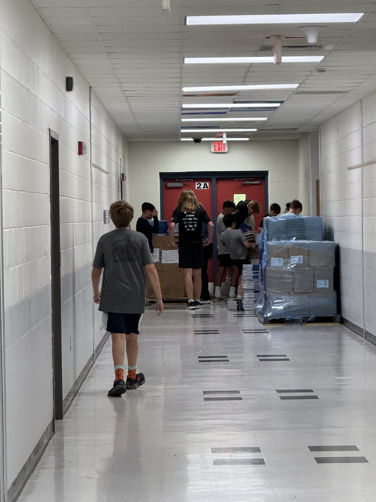 Students helping move books out of the bookroom