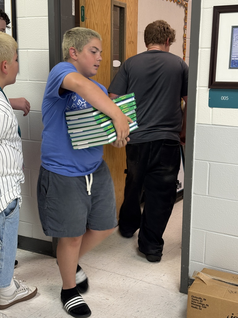Students helping move books out of the bookroom