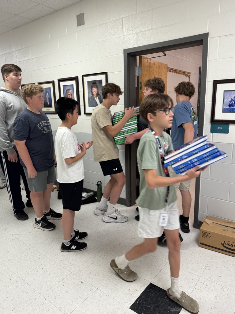 Students helping move books out of the bookroom
